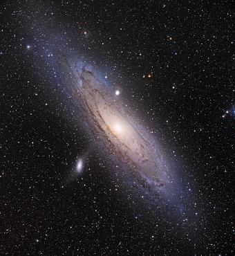 CAPTION Our Milky Way's largest neighbor, the Andromeda Galaxy, spans about 220,000 light-years across. Two of its dwarf satellite galaxies, Messier 110 (bottom left) and Messier 32 (above Andromeda's central bulge), are visible as bright white spots in this image.  CREDIT Adam Block/University of Arizona