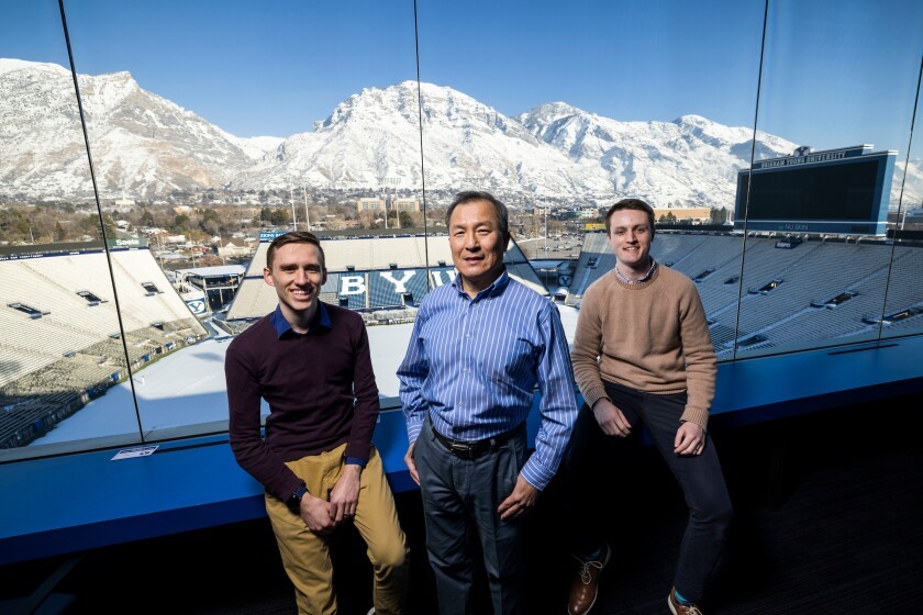 BYU professor D.J. Lee and students Shad Torrie and Andrew Sumsion sit in the press box at LaVell Edwards Stadium. Their AI technology could improve film study for college and NFL football teams. Photo by Nate Edwards/BYU Photo