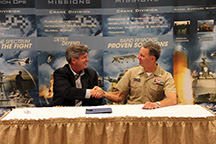 Dan Hasler (left), president and chief entrepreneurial officer of Purdue Research Foundation, shakes hands with Capt. Jeffrey "J.T." Elder, commanding officer of Naval Surface Warfare Center - Crane Division (NSWC Crane), during an Aug. 22 event. NSWC Crane and Purdue have signed a partnership intermediary agreement that will showcase both organizations' intellectual property to expedite and support the move of innovations to the public.