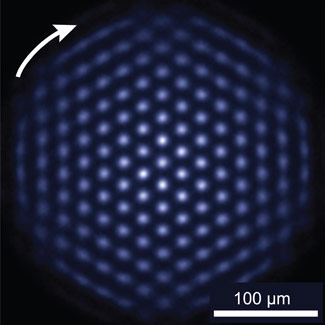 The NIST quantum simulator permits study of quantum systems that are difficult to study in the laboratory and impossible to model with a supercomputer. In this photograph of the crystal, the ions are fluorescing, indicating the qubits are all in the same state. Under the right experimental conditions, the ion crystal spontaneously forms this nearly perfect triangular lattice structure.