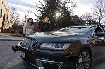 CAPTION Elke Rundensteiner, right, professor of computer science at Worcester Polytechnic Institute (WPI), and PhD student Allison Rozet, stand beside an autonomous vehicle testbed used in research at WPI. The analytics tools Rundensteiner and Rozet are developing could make driverless cars safer by analyzing data streaming from vehicles in real time.