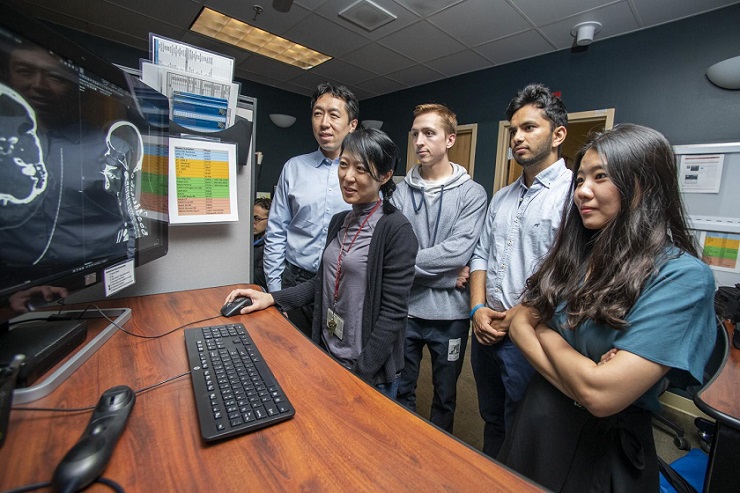 CAPTION HeadXNet team members (from left to right, Andrew Ng, Kristen Yeom, Christopher Chute, Pranav Rajpurkar and Allison Park) looking at a brain scan. Scans like this were used to train and test their artificial intelligence tool, which helps identify brain aneurysms.  CREDIT L.A. Cicero/Stanford News Service