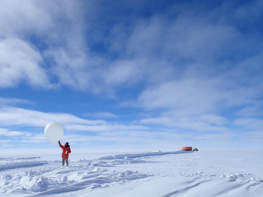 CAPTION This is a photograph showing radiosonde observation at Dome Fuji Station in Antarctica. The person in the photo is Dr. Konosuke Sugiura, a co-author of the study.  CREDIT Taichi Ito