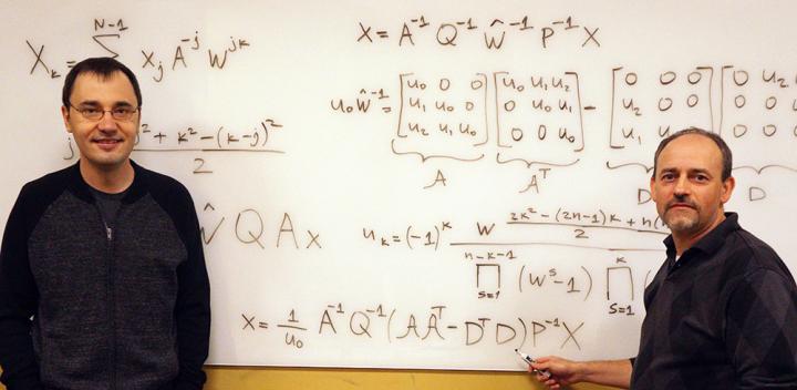 CAPTION Vladimir Sukhoy and Alexander Stoytchev, left to right, with the derivation for the ICZT algorithm in structured matrix notation -- the answer to a 50-year-old puzzle in signal processing.  CREDIT Photo by Paul Easker