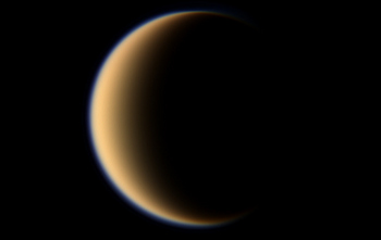 Titan is covered in a thick atmosphere with abundant methane.