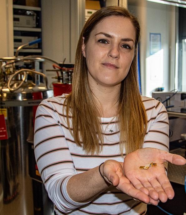 Dr Aniela Dunn holds the laser and its mounting in the palm of her hand.