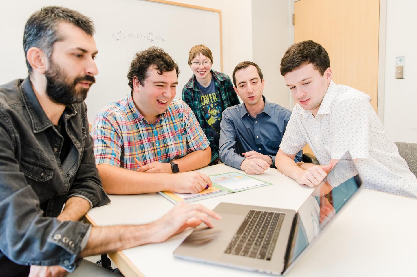 Left to right: Fatih Ersan, Can Ataca, Gracie Chaney, Jaron Kropp, and Daniel Wines, all members of Ataca's research group, discuss their work on 2D materials. These materials are one-atom-thick sheets that can have useful properties for applications from computers to solar cells and wearable electronics.  CREDIT Marlayna Demond