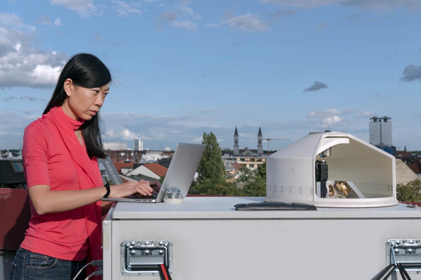 Prof. Jia Chen, Chair of Environmental Sensing and Modeling at the TUM Department of Electrical and Computer Engineering of the Technical University of Munich (TUM) at a measuring device of the MUCCnet sensor network on the roof of a building at the main campus of the TUM in Munich.  CREDIT A. Heddergott / TUM