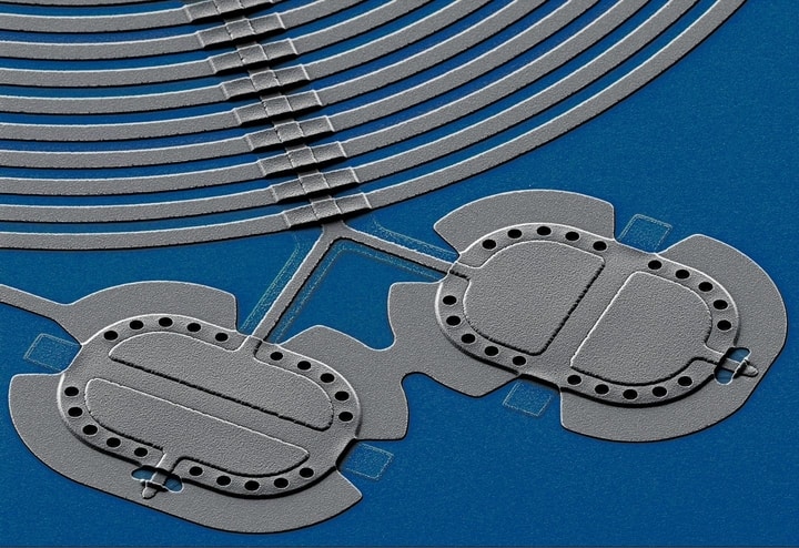 researchers entangled the beats of these two mechanical drums--tiny aluminum membranes each made of about 1 trillion atoms--and precisely measured their linked quantum properties. Entangled pairs like this (shown in this colorized micrograph), which are massive by quantum standards, might someday perform computations and transmit data in large-scale quantum networks.  CREDIT Teufel/NIST