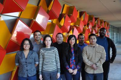 Photo shows eight of the nine students who have been awarded fellowships to assist them is securing doctoral degrees. Front row, L to R: Maricela Maldonado, Irma Ortiz, Carla De Los Santos, and Edward Laguna. Back row, L to R: Philip Soto, Mackenzie Alvarez, Jesse Benavides, and Abdullah Madany.