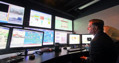 Schlumberger's software will enhance the high-tech facilities already available in the University of Arizona mining and geological engineering department and Institute for Mineral Resources, whose mine control room simulator is shown. Also pictured is Gregory H. Boyce, chairman and chief executive officer of Peabody Energy.