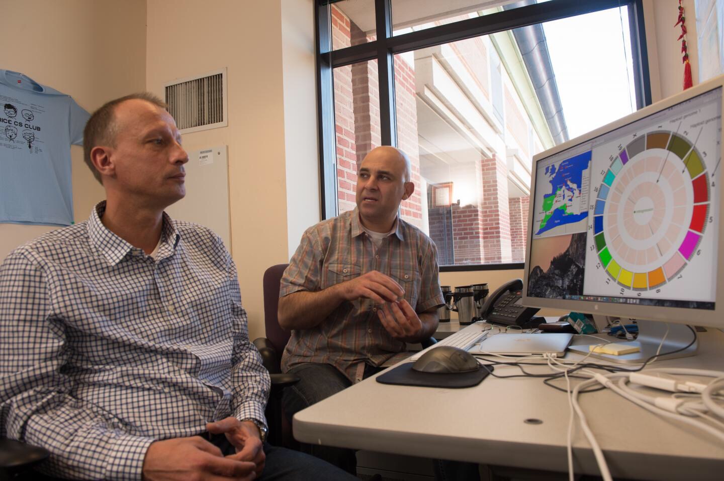 Rice University biologist Michael Kohn, left, and computer scientist Luay Nakhleh, right, discuss the results of a study of the genomes of European and African mice that showed signs of three distinct hybridization events between two mouse species. The researchers determined that such events are not unusual, though only those with traits favored by evolution survive.  Credit: Jeff Fitlow/Rice University