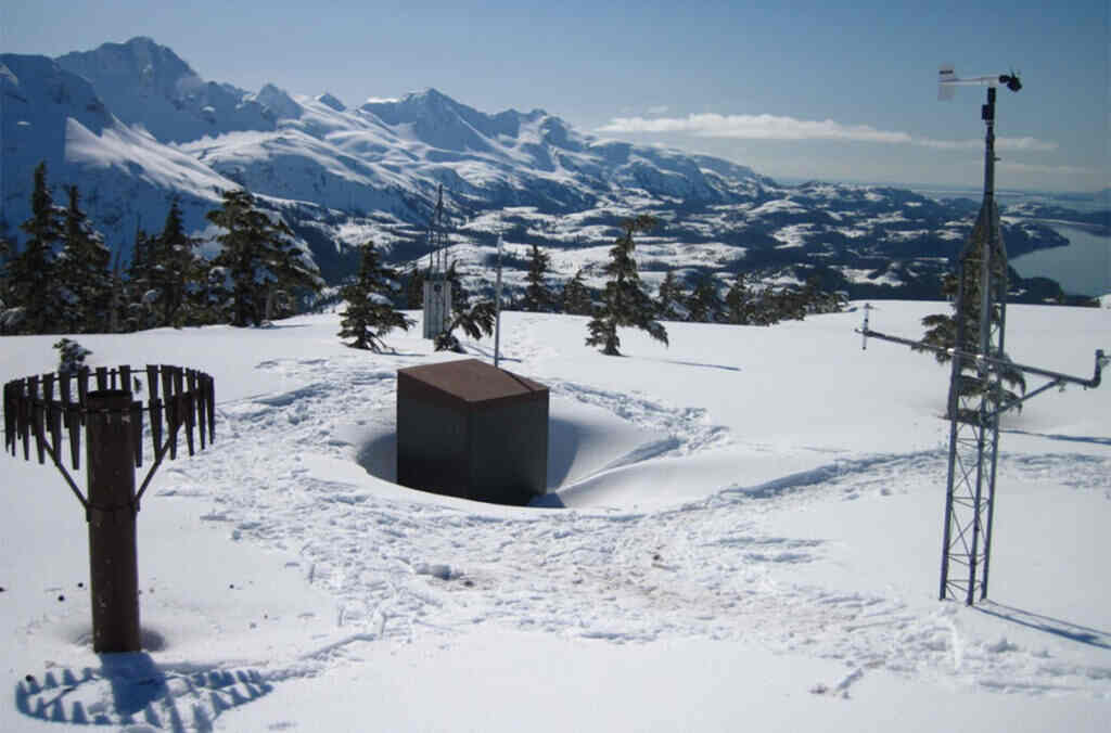 Mt. Eyak SNOTEL site, above the coastal town of Cordova, Alaska. Snow depth is about 10.5 feet, 45% density. Taken April 2012. Photo by Daniel Fisher of the USDA Natural Resources Conservation Service.