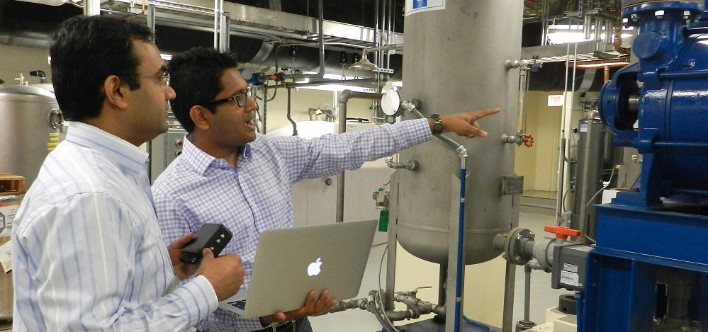 Lokesh Gupta, from left, and Anurag Garg of Bearing Analytics survey locations to install the company's sensors that monitor industrial rotating systems. Bearing Analytics is one of more than 20 startups created in fiscal year 2014 from Purdue University innovations. (Purdue Research Foundation photo) 