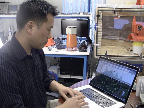 Johnny Park, president and CEO of Spensa Technologies, reviews insect data collected in an agricultural field and placed on Mytraps.com. Mytraps.com is an online application that will help growers and pesticide consultants electronically track the number of insects in crops to better control insect crop damage and improve the use of insecticides. (Purdue Research Park photo)