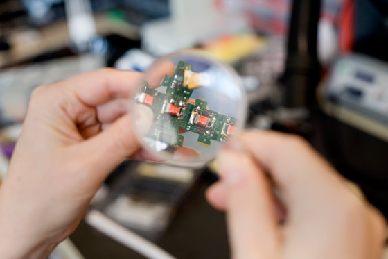 To attach to each other, to communicate and to share power, the cubes use 'electropermanent magnets,' materials whose magnetism can be switched on and off with jolts of electricity. Each cube has magnets — recognizable by the reddish wires wrapped around them — on four of its six faces. Photo: M. Scott Brauer