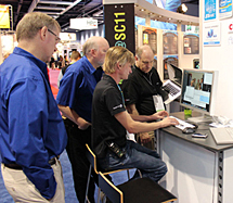 NASA network engineers consult with demo partners at SC11 meeting. From left to right: Paul Lang (NASA), Bill Fink (NASA), Steve Cotter (Alcatel-Lucent), and Matt Zekauskas (Internet2). Photo by Jarrett Cohen